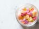 Photo d'une coupe en verre remplie de bonbons roses et jaunes pour illustrer cet article sur l'envie de sucre